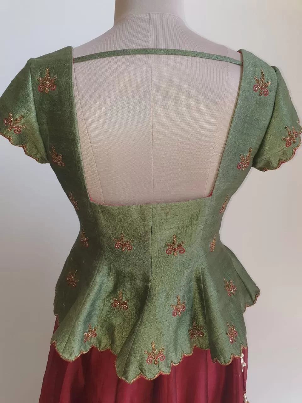 Regal Green Embroidered Peplum Corset with maroon skirt